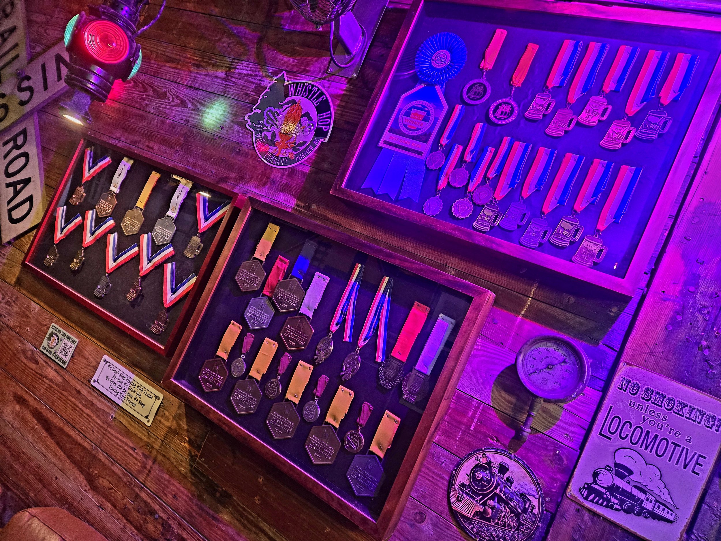 Wall of medals and ribbons won by Whistle Hop Brewing Company